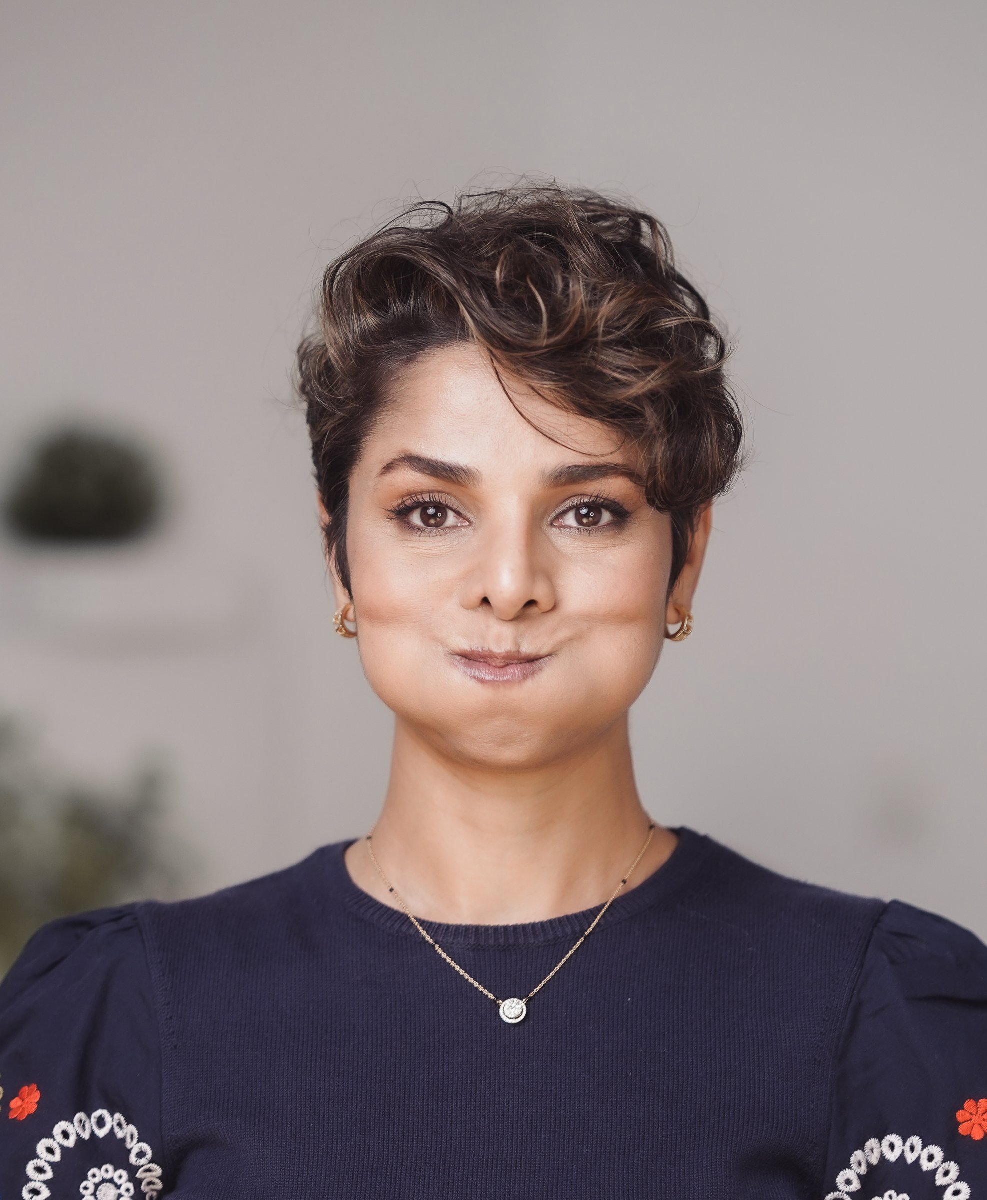 Holding the cheek-puff while lifting the cheeks into a smile against the pressure