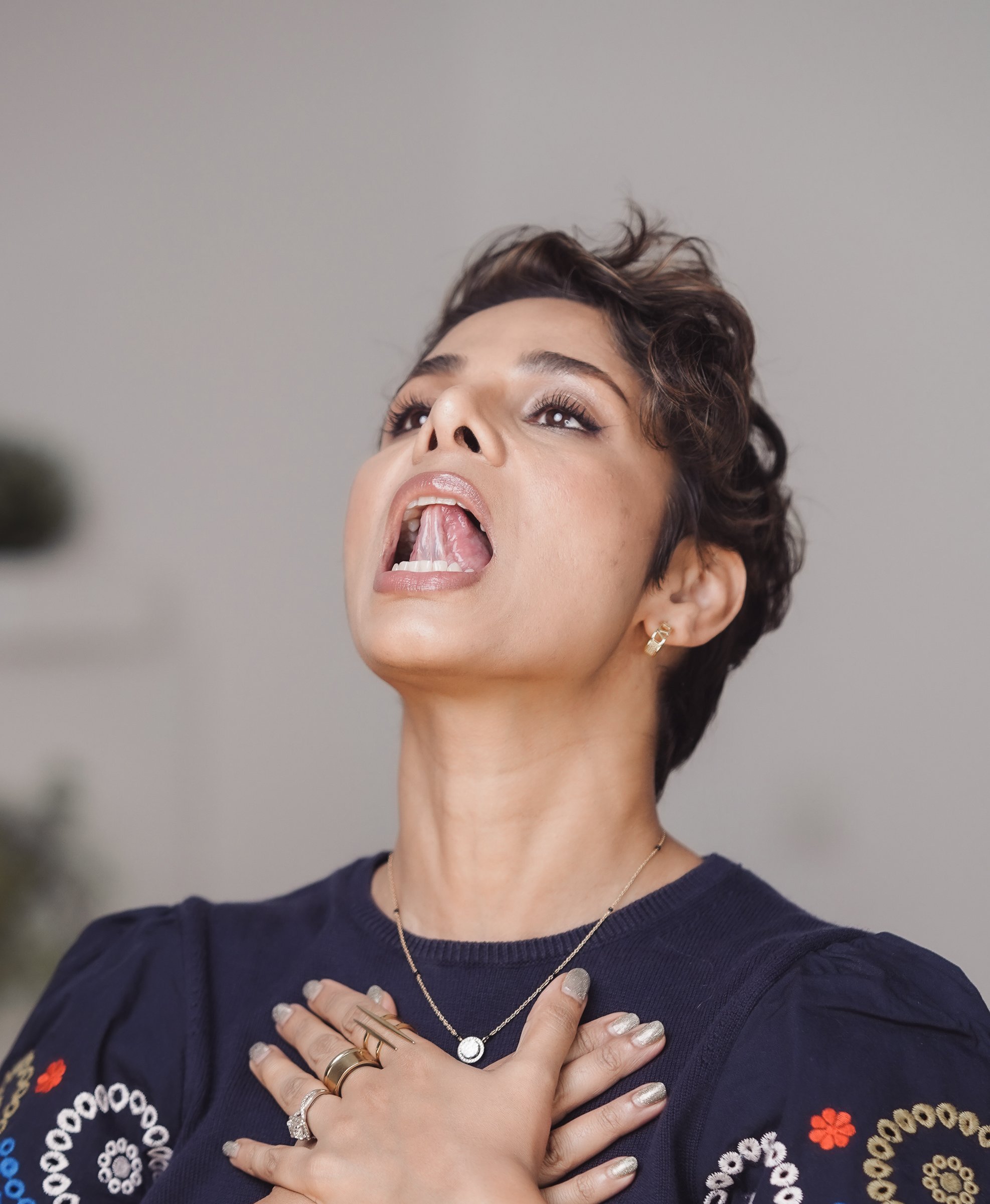 Head tilted back with the tongue pressed to the roof of the mouth