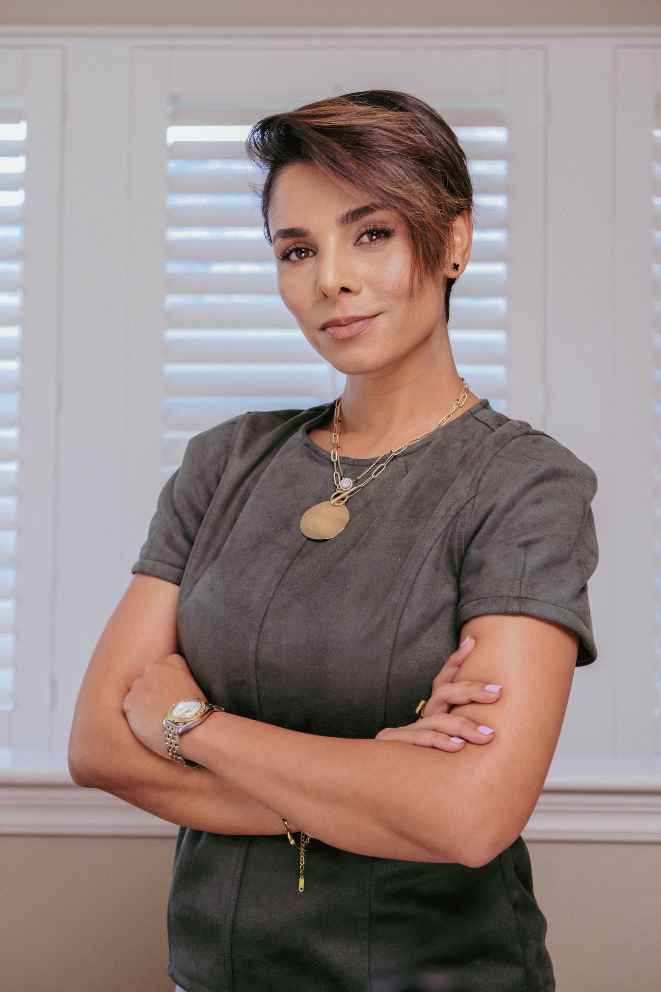 Parmita Katkar standing with her arms crossed, open and grounded posture